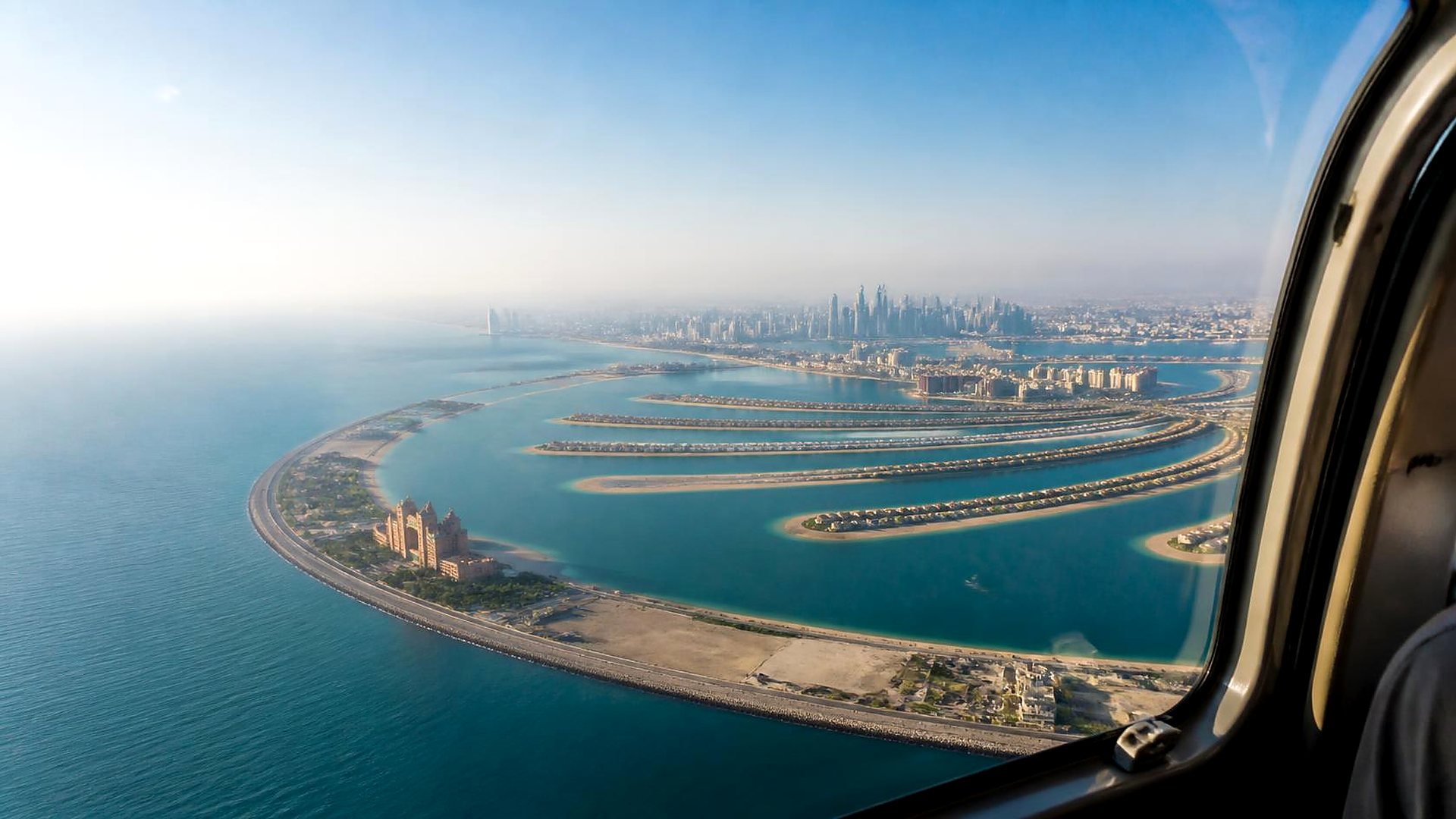 Palm Jumeirah and the Dubai coast seen through a helicopter window