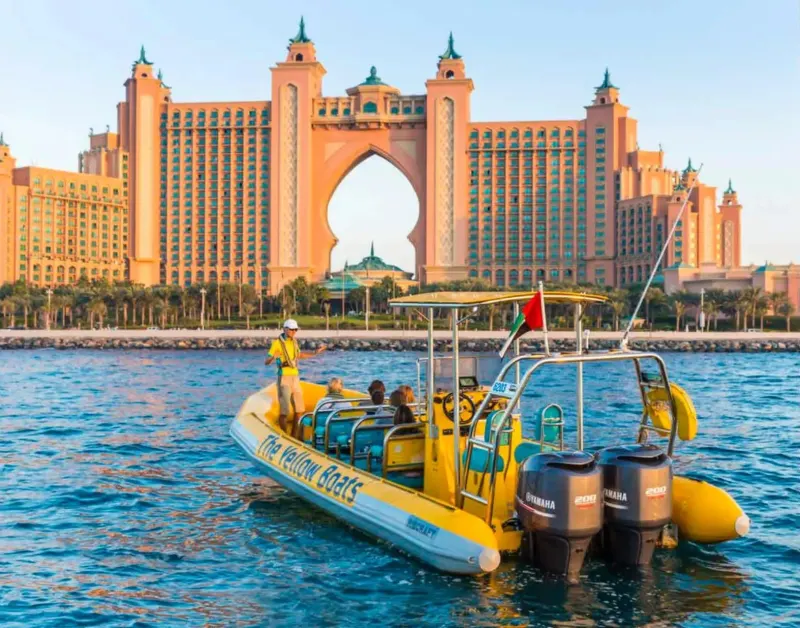 Yellow speedboat on the sea in front of Atlantis The Palm