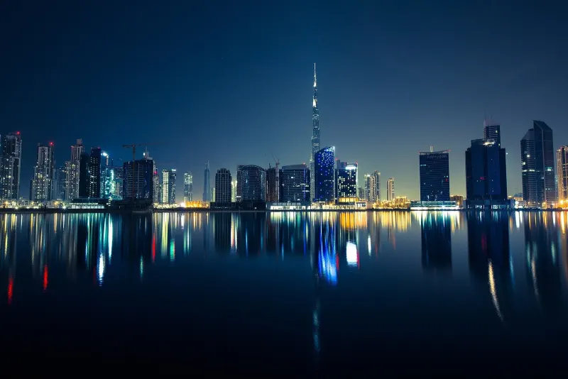 Burj Khalifa and the Business Bay towers reflected in the water at night