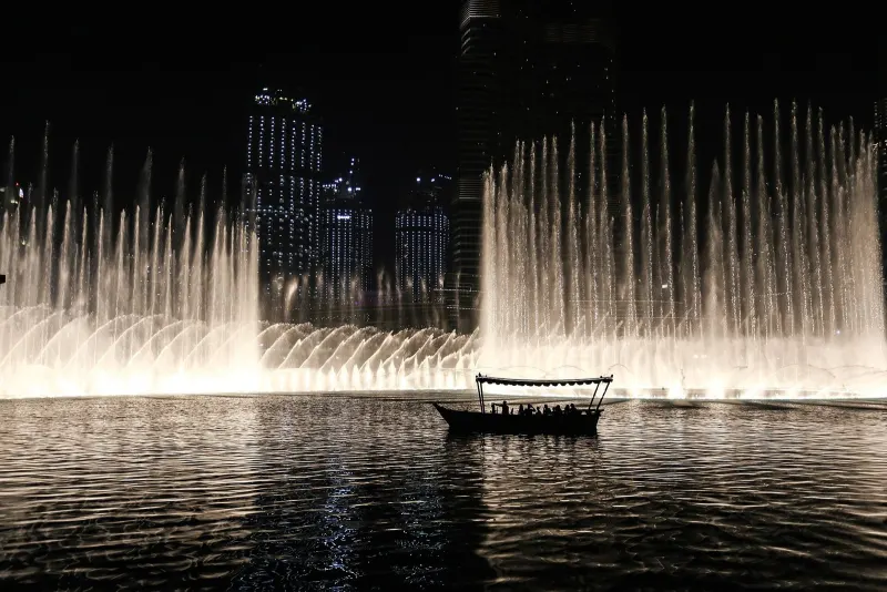 Wooden abra on Burj Lake during the evening fountain show