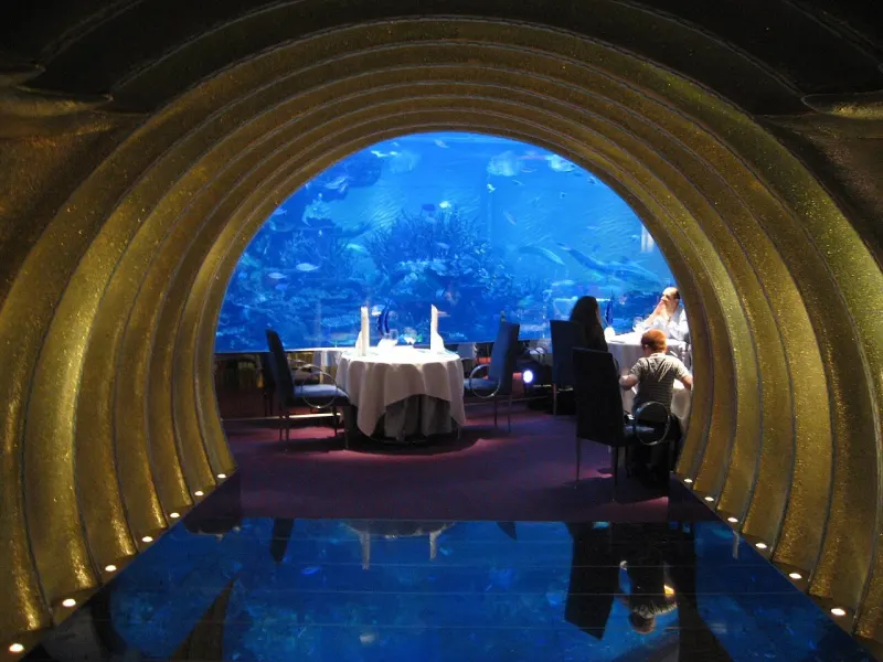 Golden entrance arch of Al Mahara restaurant with its aquarium, Burj Al Arab