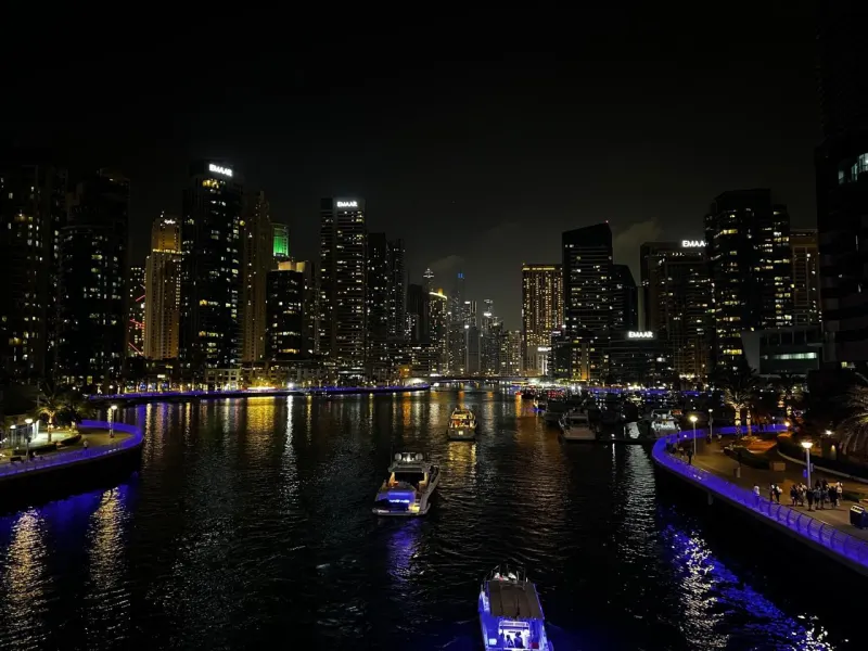 Yacht cruising through Dubai Marina at night