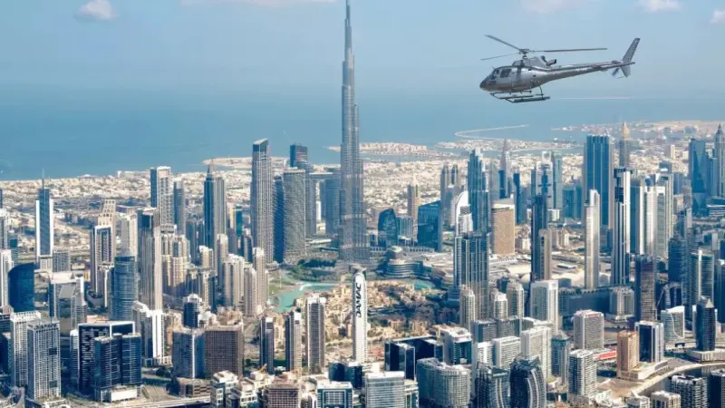 Helicopter flying past the Burj Khalifa and the Downtown Dubai skyline
