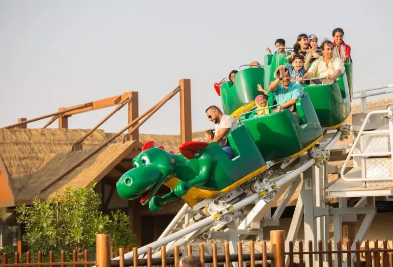 Riders on a dragon roller coaster at LEGOLAND Dubai